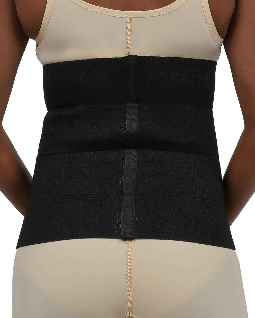 Rear view of the Vita abdominal binder, demonstrating the full lumbar support and smooth profile under clothing for post-surgical recovery.